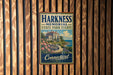 A metal sign with the text "HARKNESS MEMORIAL STATE PARK ESTATE Connecticut" is displayed on a wooden wall.
