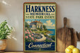 A vintage-style sign for the Harkness Memorial State Park Estate in Connecticut, featuring a picturesque illustration of a mansion overlooking a scenic landscape.