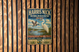 A vintage metal sign for the Harris Neck National Wildlife Refuge in Georgia, featuring an illustration of a bird and a seagull.