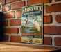 A vintage-style metal sign for the National Wildlife Refuge in Georgia, featuring an illustration of a crane and other wildlife in a grassy field.