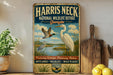 A vintage-style metal sign for the National Wildlife Refuge in Georgia, featuring illustrations of birds and wetlands.