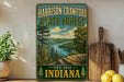 A vintage-style metal sign for the Harrison-Crawford State Forest in Indiana, featuring a scenic landscape with a river and forest.