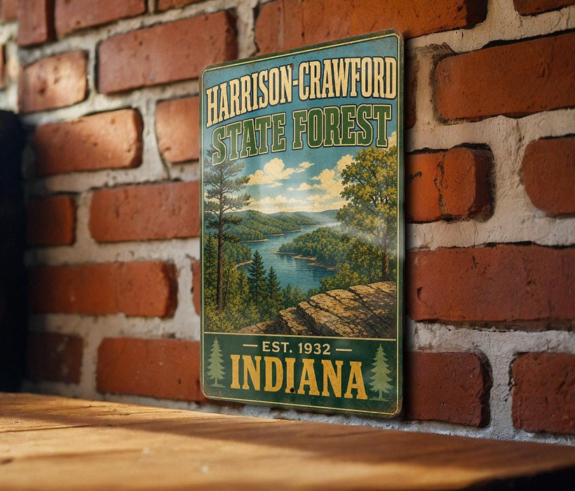 A vintage metal sign for Harrison-Crawford State Forest, featuring a scenic landscape with a river and trees, is displayed on a brick wall.