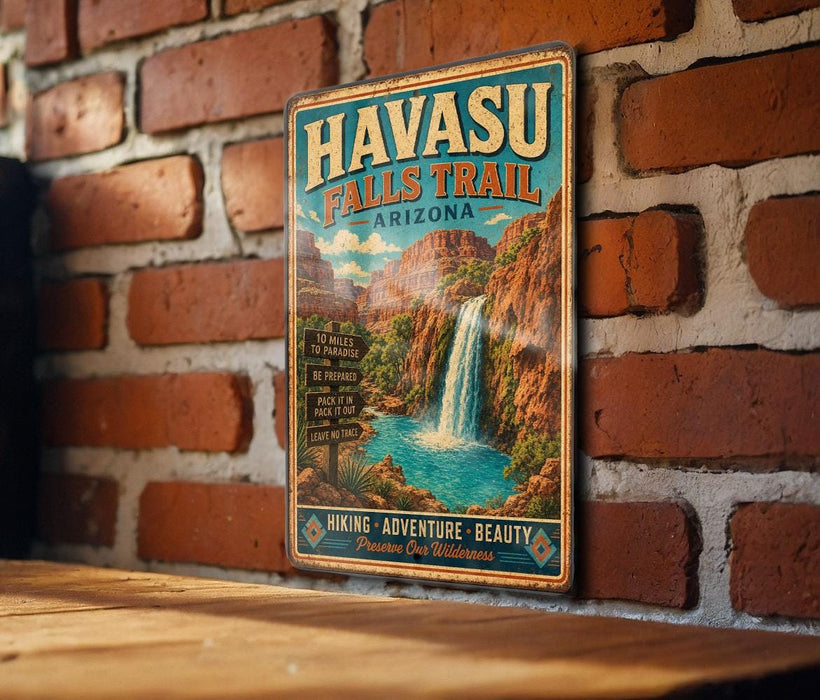 A vintage-style metal sign for Havasu Falls Trail in Arizona, featuring a waterfall and mountains in the background.