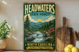 A vintage-style sign for the Headwaters State Forest in North Carolina, featuring a scenic landscape with a river, mountains, and pine trees.
