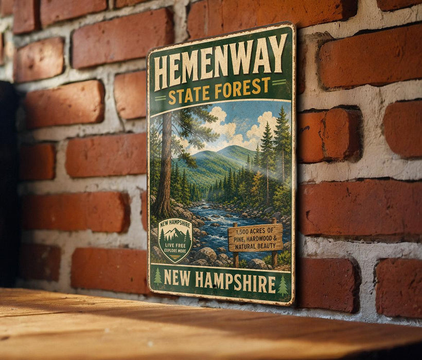 A vintage-style metal sign for Hemenway State Forest in New Hampshire, featuring a scenic mountain landscape with a river and pine trees.