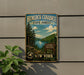 A vintage-style metal sign for Hemlock-Canadice State Forest in New York, featuring a scenic landscape with pine trees, a lake, and mountains.