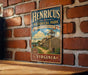 A vintage-style metal sign for Henricus Historical Park in Virginia, featuring a depiction of a historic fort and a banner with the text "Step into Virginia's Past".