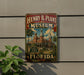 A vintage-style metal sign for the Henry B. Plant Museum in Florida, featuring an illustration of a historic building surrounded by palm trees.