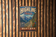 A vintage-style metal sign for the Highline Trail in Montana, featuring a mountain landscape and trail map.