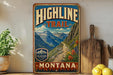 A vintage-style sign for the Highline Trail in Montana, featuring a scenic mountain landscape with a winding path and colorful wildflowers.