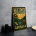 A vintage-style metal sign for the Hightower Forest in Georgia, featuring a scenic illustration of the forest and a sunset.