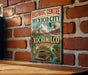A vintage-style metal sign for the Historic Centre of Mexico City, featuring an illustration of the city's landmarks and a boat on the water.
