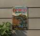 A vintage-style metal sign for the Historic Centre of Oporto, featuring an illustration of the Luiz I Bridge and the Monastery of Serra do Pilar.
