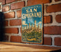 A vintage-style metal sign with the text "HISTORIC CENTRE OF SAN GIMIGNANO ITALY" and an illustration of a cityscape, mounted on a brick wall.