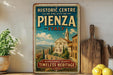 A vintage-style sign for the Historic Centre of the City of Pienza, Italy, featuring an illustration of a historic building and landscape.