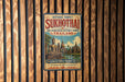a vintage-style sign for the historic town of Sukhothai, Thailand, with a wooden fence in the background.