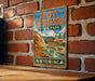 A vintage-style sign for Hot Springs State Park in Wyoming, featuring a scenic illustration of the park's natural beauty.