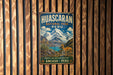 A vintage-style metal sign for Huascaran National Park in Peru, featuring a mountain landscape with a llama and text promoting the park's natural heritage.