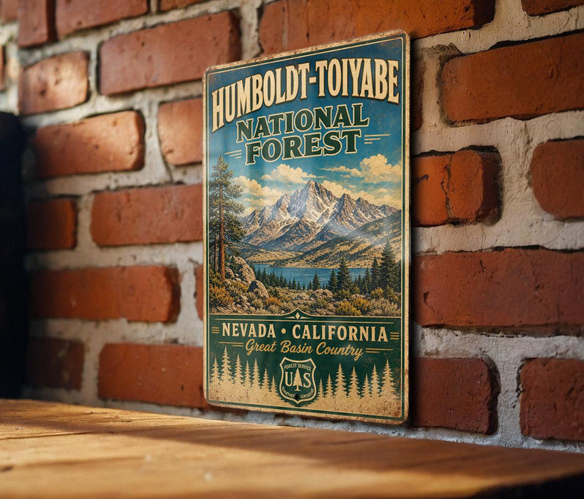 A vintage-style metal sign for Humboldt-Toiyabe National Forest in Nevada, California, with a mountain landscape and pine trees.
