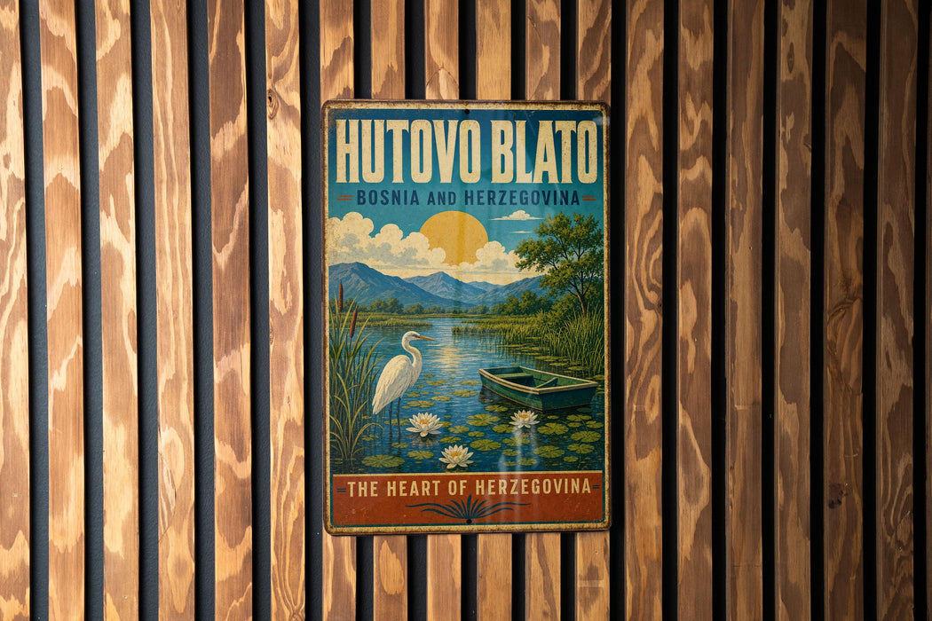 A vintage-style metal sign with a scenic illustration of a lake, boat, and birds, mounted on a wooden wall.
