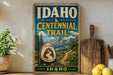 A vintage-style sign for the Idaho Centennial Trail, featuring a mountain landscape and the text "Idaho Centennial Trail" prominently displayed.