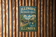 A vintage-style sign for the Illinois and Michigan Canal, featuring a scenic illustration of a canal and a building, mounted on a wooden wall.