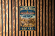 a vintage-style sign that reads "INCENSE ROUTE DESERT CITIES IN THE NEGEV ISRAEL" with a desert cityscape illustration.