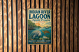 A vintage metal sign for the Indian River Lagoon Aquatic Preserve in Florida, featuring an illustration of a manatee and a turtle in a lagoon setting.