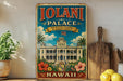 A vintage-style sign for the Iolani Palace in Hawaii, featuring an illustration of the palace surrounded by tropical foliage and flowers.
