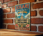 A vintage-style sign for the Iolani Palace in Hawaii, featuring a building illustration and tropical elements.