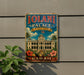 A vintage-style metal sign for the Iolani Palace, the official residence of the Governor of Hawaii, is displayed on a wall.