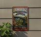a vintage-style metal sign with the text "Ironbridge Gorge United Kingdom" and "The Birthplace of Industry" on it, hanging on a wall.