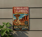 A vintage-style metal sign advertising the Ichigualasto Talpaya, a famous natural landmark in Argentina.