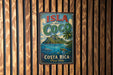 A vintage-style metal sign with the text "ISLA del COCO" and "COSTA RICA Puro Vida" is displayed on a wooden wall.