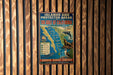 A vintage metal sign promoting the Gulf of California, featuring a map and illustrations of marine life, is displayed on a wooden wall.