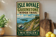 A vintage-style metal sign for Isle Royale Greenstone Ridge Trail, featuring a scenic mountain landscape with a moose, surrounded by lush greenery and a winding trail.