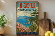 A vintage-style poster advertising Izu Peninsula Park in Japan, featuring a scenic landscape with a mountain, ocean, and flowers.