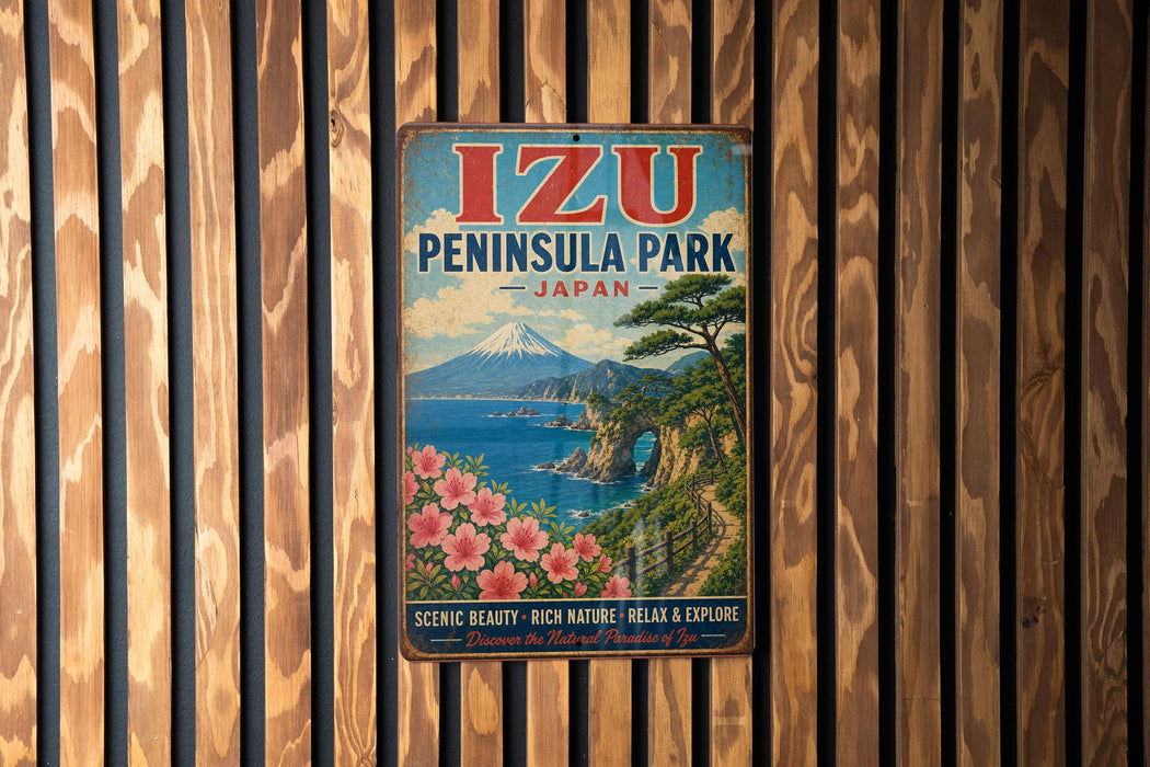 A vintage metal sign for Izu Peninsula Park in Japan, featuring a scenic landscape with a mountain, ocean, and flowers.