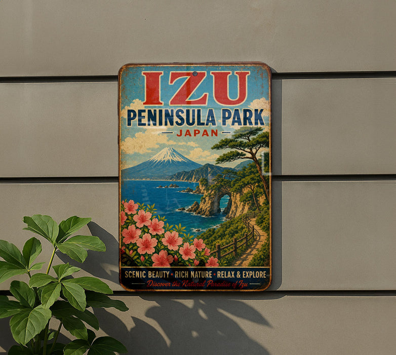 A vintage-style metal sign for Izu Peninsula Park in Japan, featuring a scenic landscape with a mountain, ocean, and flowers.