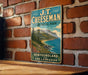 A vintage-style metal sign for J.T. Cheeseman Provincial Park, New Brunswick and Labrador, featuring a scenic mountain landscape.