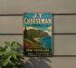 A vintage metal sign for J.T. Cheeseman Provincial Park, featuring a scenic mountain landscape with a lake and coastal area.