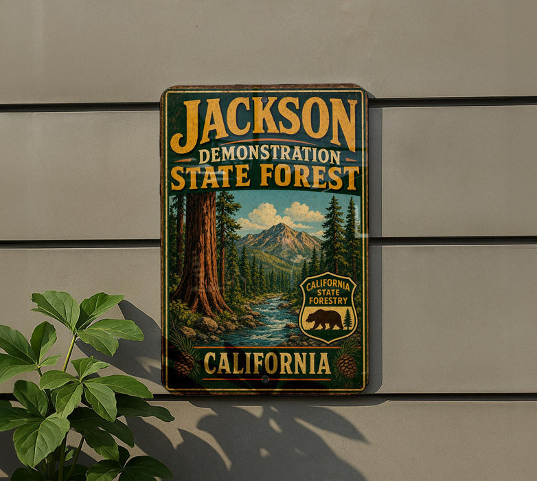 A metal sign displaying the name "JACKSON DEMONSTRATION STATE FOREST" and the words "California State Forest" is affixed to a wall.