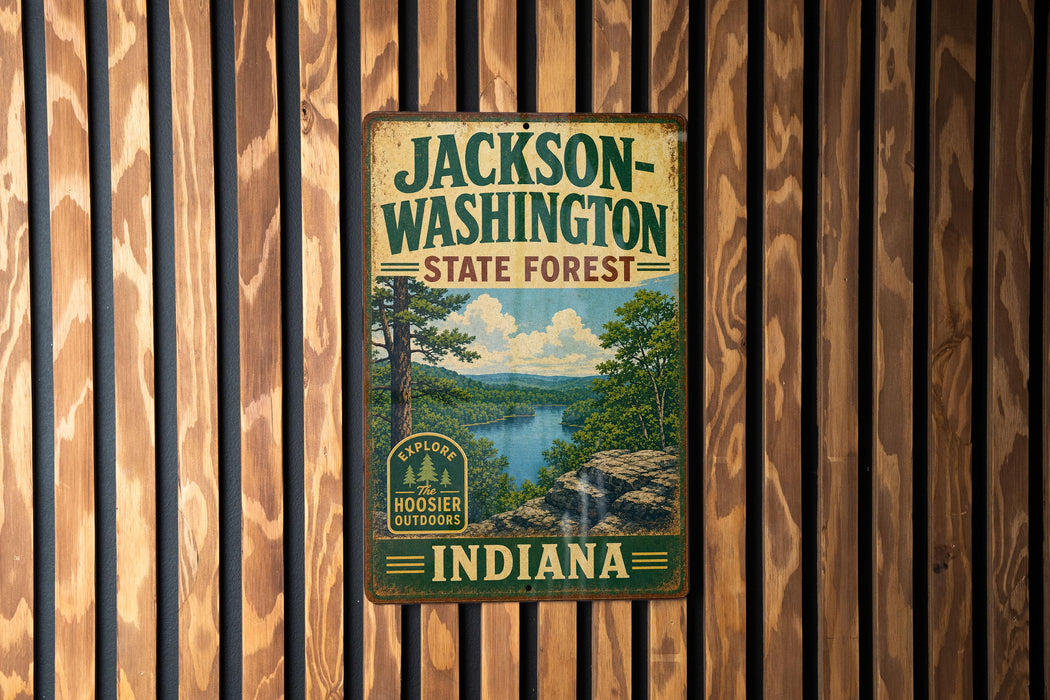 A vintage metal sign for Jackson-Washington State Forest, Indiana, featuring a scenic landscape with a river and trees.