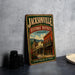 A vintage-style metal sign for the Jacksonville Historic District in Oregon, featuring an illustration of a historic building and the text "Step back in time".