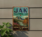 A vintage-style metal sign for "Jak Territorial Park" is displayed on a wall, featuring a scenic mountain landscape with a river and pine trees.