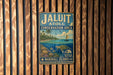 A vintage metal sign for the Jaluit Conservation Area in the Marshall Islands, featuring a tropical beach scene with palm trees, a sailboat, and a turtle.