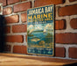 A vintage-style metal sign for Jamaica Bay, New York, featuring illustrations of a bird, fish, and a sailboat, along with the text "JAMAICA BAY MARINE PROTECTED AREA NEW YORK" and the phrases "PROTECT • PRESERVE • ENJOY".