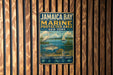 A metal sign with text and illustrations is attached to a wooden wall.
