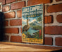 A vintage-style metal sign for the James Campbell National Wildlife Refuge in Hawaii, featuring a bird and tropical landscape.